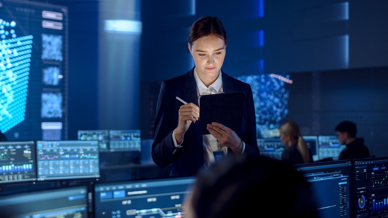 woman working on tablet in control room