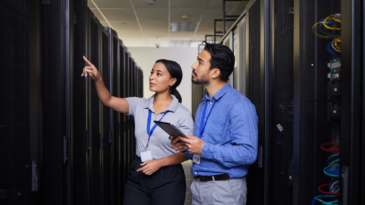 male and female colleagues working on a computer in a cyber stack